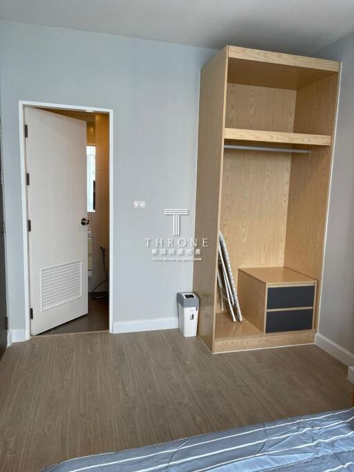 Bright bedroom with wooden built-in wardrobe and light blue walls