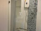 Modern bathroom with glass shower door and wall-mounted shower head