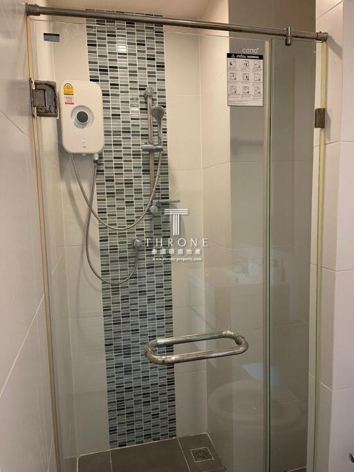 Modern bathroom with a glass shower enclosure and a water heater