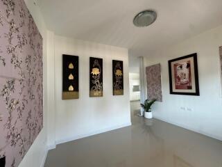 Modern hallway with artistic wall decorations and tiled floor