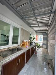 Spacious balcony with kitchenette and sitting area