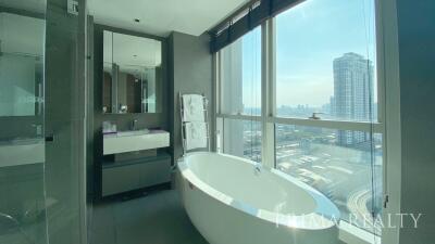 Modern bathroom with freestanding tub and floor-to-ceiling windows