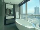 Modern bathroom with freestanding tub and floor-to-ceiling windows