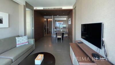 Modern living room leading to an open dining area with contemporary design