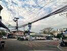 Street view with visible power lines and parking lot