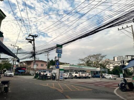 Street view with visible power lines and parking lot