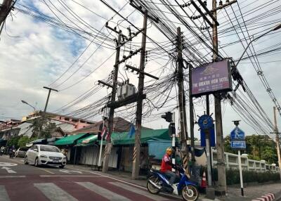Busy street with electrical power lines and advertising billboard
