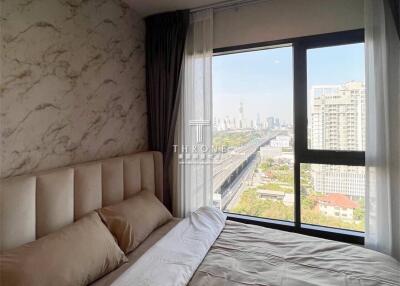 Bright and cozy bedroom with large window and city view