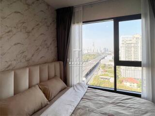 Bright and cozy bedroom with large window and city view