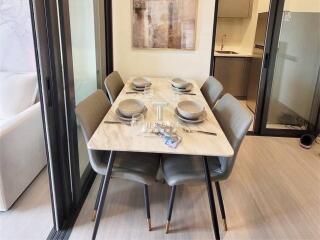 Modern dining area with a marble table and comfortable seating