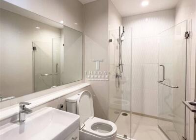 Modern bathroom with a glass shower enclosure and white fixtures