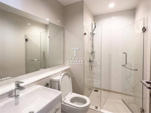 Modern bathroom with a glass shower enclosure and white fixtures