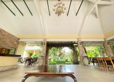 Spacious patio area with high ceiling and natural view