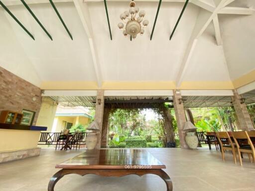 Spacious patio area with high ceiling and natural view
