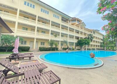 Residential building with swimming pool and lounging chairs