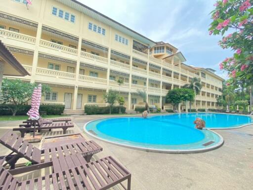 Residential building with swimming pool and lounging chairs