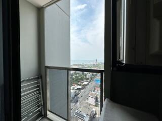High-rise bedroom with cityscape view through large window