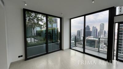 Spacious living room with large windows offering city view
