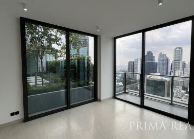 Spacious living room with large windows offering city view