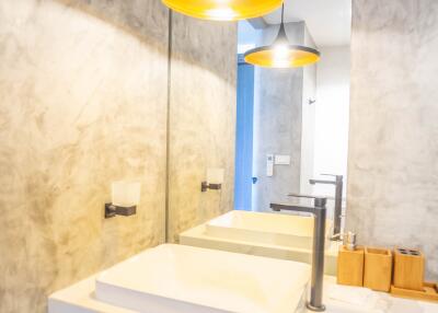 Modern bathroom interior with stylish sink and elegant pendant lights