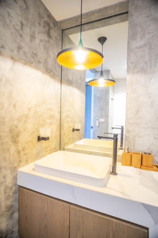 Modern bathroom interior with stylish sink and elegant pendant lights