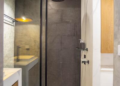 Modern bathroom interior with glass shower and wooden accents