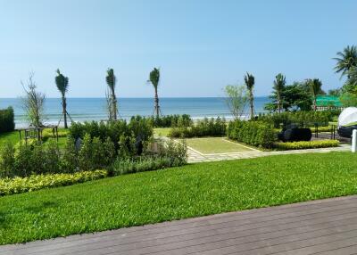 Lush garden and lawn with ocean view and comfortable seating area