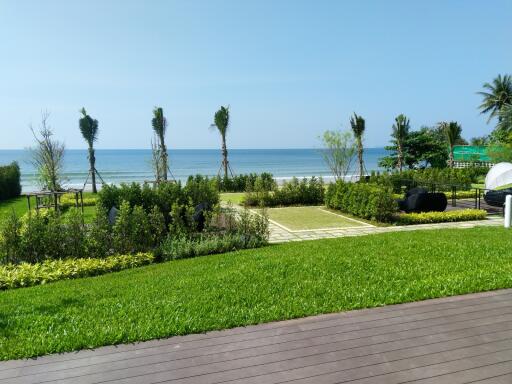 Lush garden and lawn with ocean view and comfortable seating area