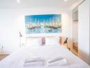 Bright and airy bedroom with a large painting above the bed
