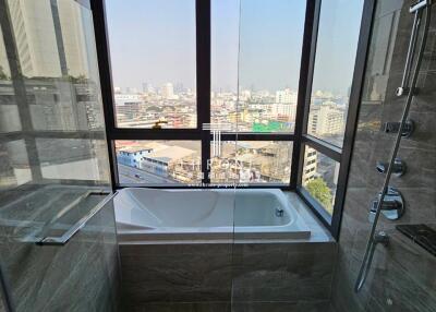 Modern bathroom with city view through large window