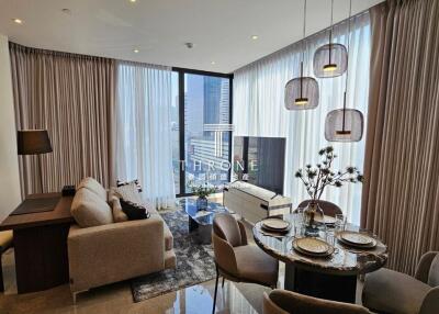 Elegant living room with dining area and city view