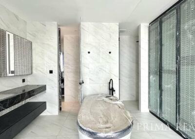 Contemporary bathroom with marble tiles and glass shower enclosure