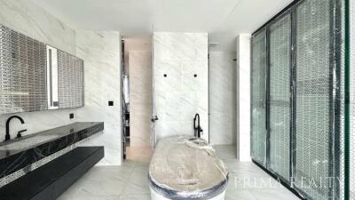 Contemporary bathroom with marble tiles and glass shower enclosure