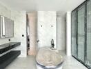 Contemporary bathroom with marble tiles and glass shower enclosure