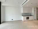 Spacious unfurnished apartment interior with open floor plan, kitchen, and large windows