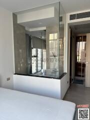 Modern bedroom with a unique glass-walled en-suite bathroom