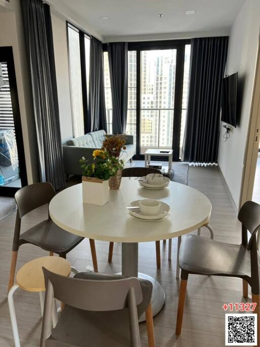 Modern living room with dining area and city view