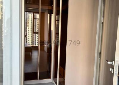 Entryway with open wardrobe and a view into the apartment