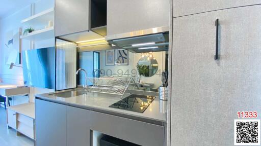 Modern kitchen with stainless steel appliances and gray cabinetry