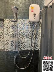Modern bathroom with wall-mounted shower and water heater