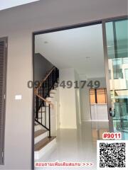 Modern home entrance with staircase and sliding glass doors
