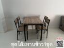 Spacious dining area with large wooden table and chairs