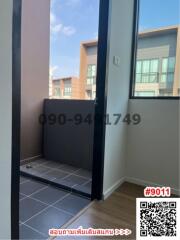 Compact balcony with tiled floor and view of adjacent buildings