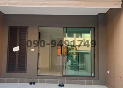 Front exterior view of a modern townhouse with glass door entrance