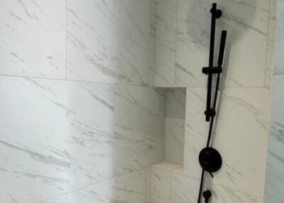 Modern bathroom with marble tiles and rainfall showerhead