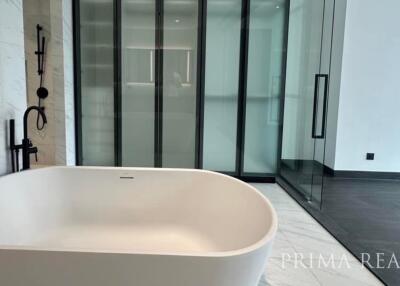 Elegant modern bathroom with a freestanding tub and glass shower enclosure