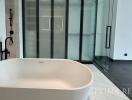 Elegant modern bathroom with a freestanding tub and glass shower enclosure