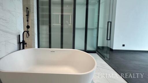 Elegant modern bathroom with a freestanding tub and glass shower enclosure