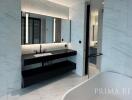 Modern bathroom with marble walls, double vanity, and walk-in shower