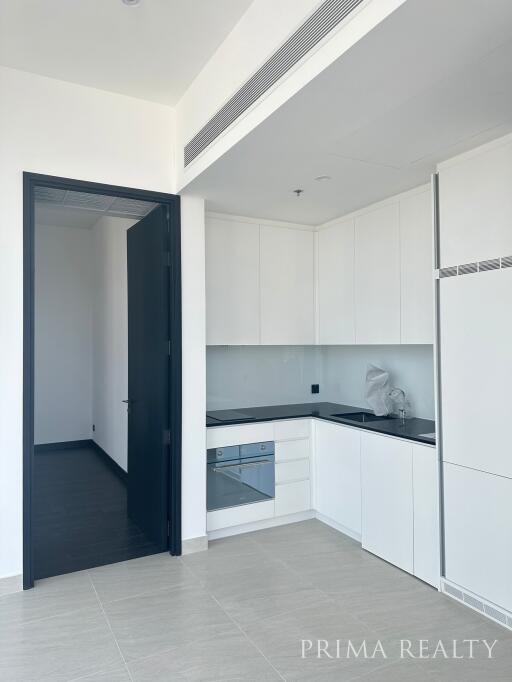 Modern kitchen with white cabinets and built-in appliances